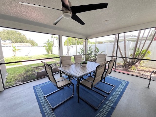 Screened lanai with outdoor dining at Serenity Living Home Care on Buttercup Circle